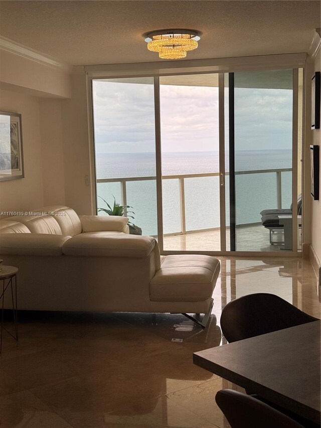 living area featuring a water view and expansive windows