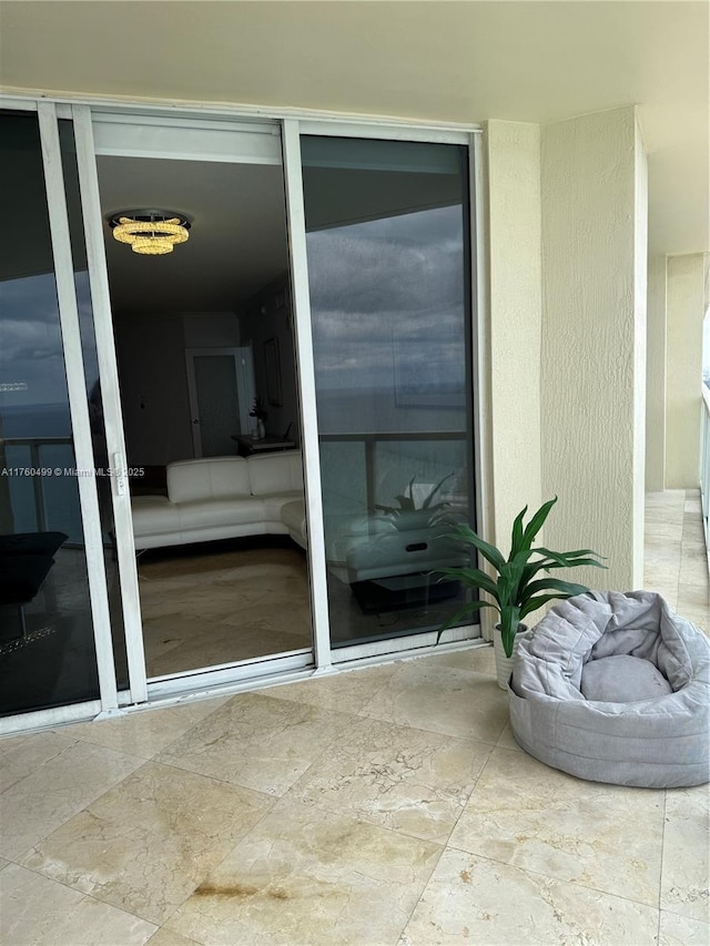 property entrance with stucco siding and driveway