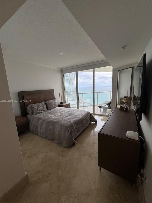 bedroom with expansive windows and access to outside