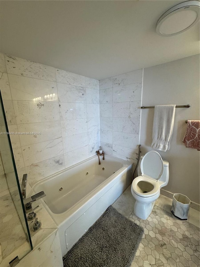 bathroom with tile patterned flooring, toilet, a jetted tub, and baseboards