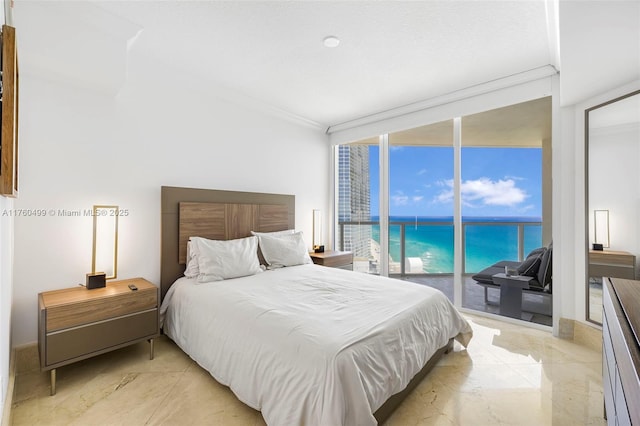 bedroom featuring a wall of windows, ornamental molding, a water view, and access to outside
