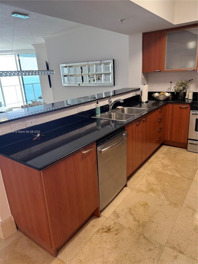 kitchen with a sink, dark countertops, appliances with stainless steel finishes, a peninsula, and brown cabinetry