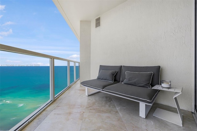 balcony featuring visible vents and a water view