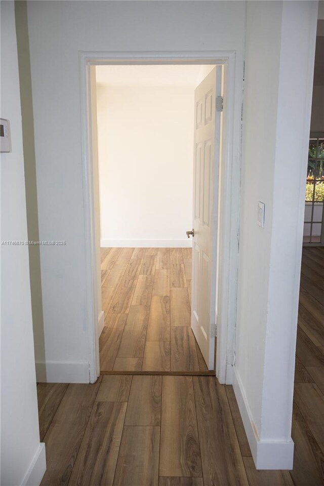 8926 Dickens Ave, Surfside, FL 33154 - hallway featuring wood finished floors and baseboards