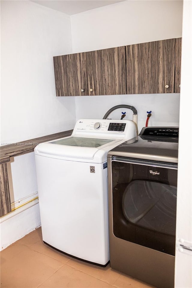 washroom featuring light tile patterned flooring and separate washer and dryer