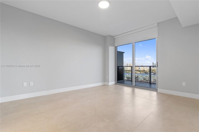 16385 Biscayne Blvd Unit 1921, North Miami Beach, FL 33160 - spare room featuring baseboards