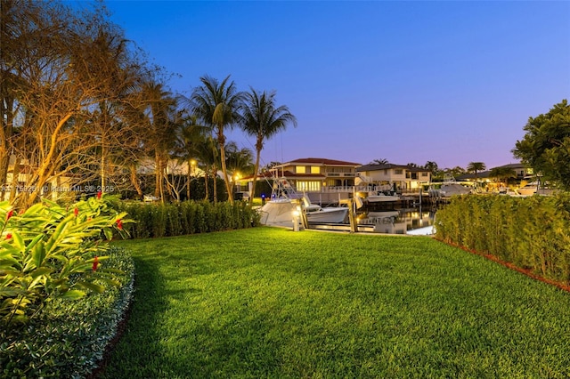 1117 Bella Vista Ave, Coral Gables, FL 33156 - yard at dusk featuring a dock, boat lift, and a water view