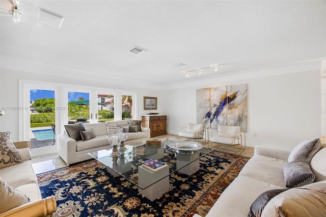 1117 Bella Vista Ave, Coral Gables, FL 33156 - living room featuring track lighting, baseboards, a textured ceiling, and visible vents