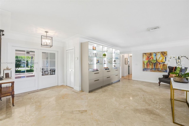 1117 Bella Vista Ave, Coral Gables, FL 33156 - entrance foyer with marble finish floor, visible vents, french doors, baseboards, and a notable chandelier