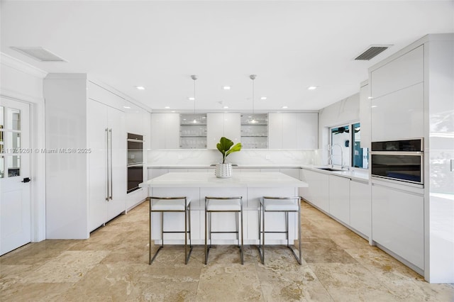 1117 Bella Vista Ave, Coral Gables, FL 33156 - kitchen featuring white cabinets, modern cabinets, and visible vents