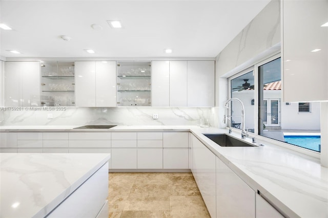 1117 Bella Vista Ave, Coral Gables, FL 33156 - kitchen with modern cabinets, white cabinets, light stone counters, and a sink