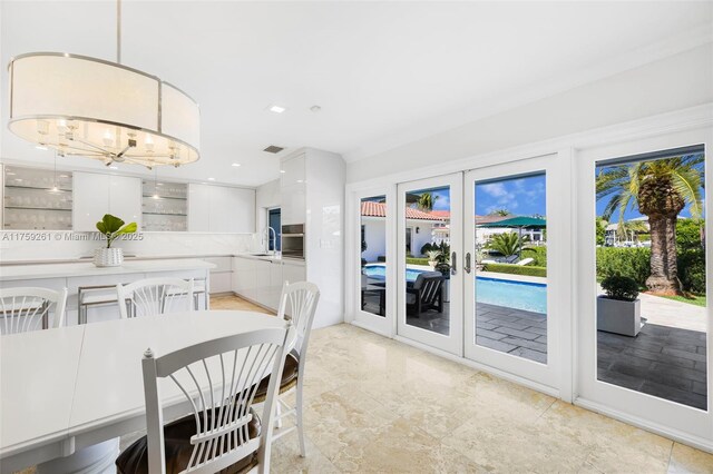 1117 Bella Vista Ave, Coral Gables, FL 33156 - dining space with french doors, visible vents, and an inviting chandelier