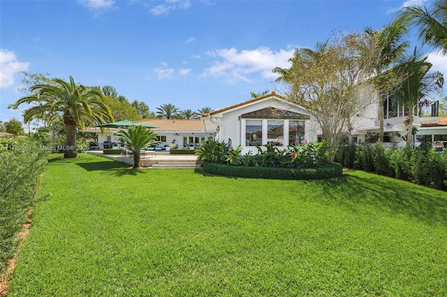 1117 Bella Vista Ave, Coral Gables, FL 33156 - rear view of property with a tile roof, stucco siding, and a lawn