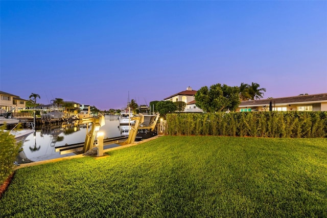1117 Bella Vista Ave, Coral Gables, FL 33156 - yard at dusk with a water view, a dock, and boat lift
