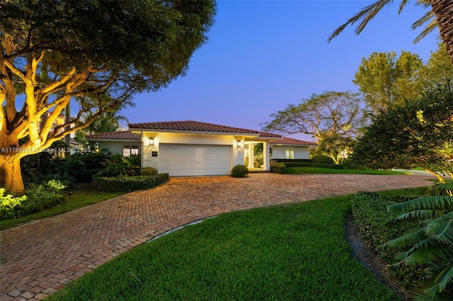 1117 Bella Vista Ave, Coral Gables, FL 33156 - view of front of property featuring decorative driveway, a tiled roof, an attached garage, a front yard, and stucco siding