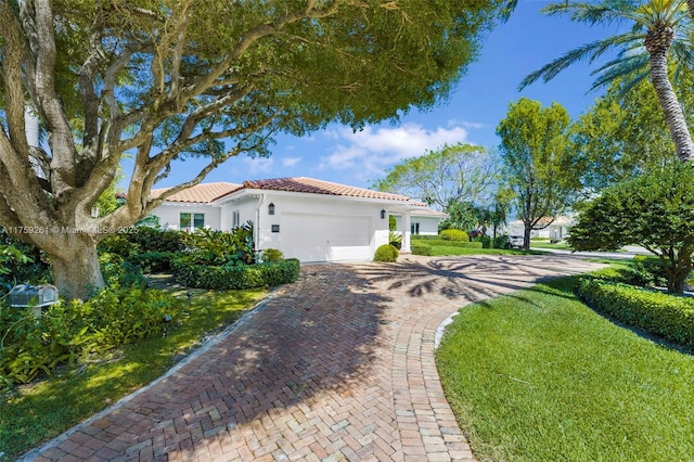1117 Bella Vista Ave, Coral Gables, FL 33156 - view of home's exterior featuring an attached garage, a tile roof, stucco siding, and decorative driveway