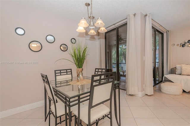 dining area with expansive windows, a textured ceiling, light tile patterned floors, baseboards, and a chandelier