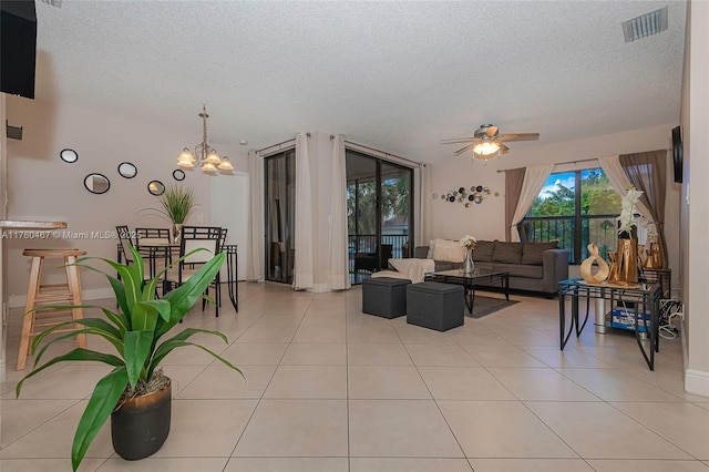 2888 S Carambola Cir S Unit 2079, Coconut Creek, FL 33066 - living area with a textured ceiling, a ceiling fan, a chandelier, and light tile patterned floors