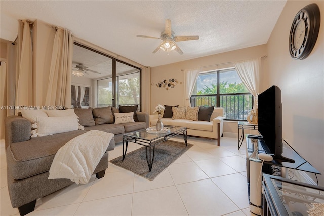 2888 S Carambola Cir S Unit 2079, Coconut Creek, FL 33066 - living room featuring ceiling fan, a textured ceiling, and light tile patterned flooring