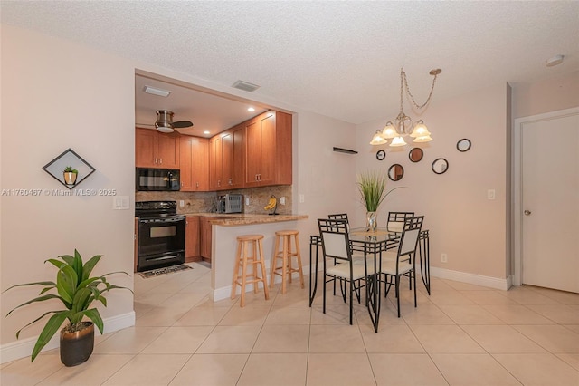 dining room featuring baseboards, visible vents, light tile patterned flooring, a textured ceiling, and a notable chandelier