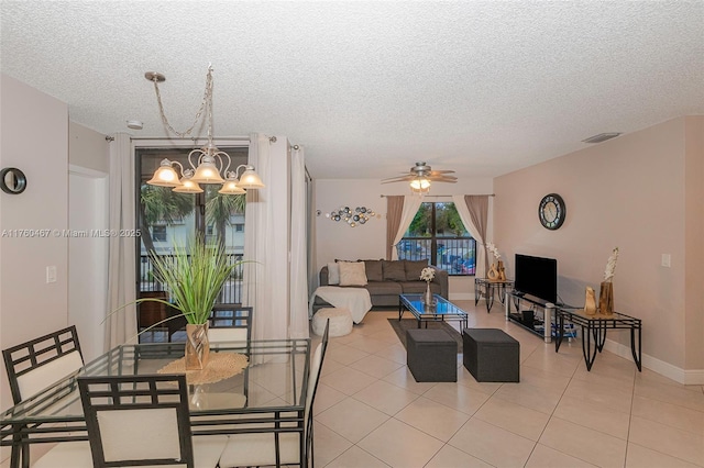 2888 S Carambola Cir S Unit 2079, Coconut Creek, FL 33066 - living room featuring a chandelier, a textured ceiling, ceiling fan, and light tile patterned floors