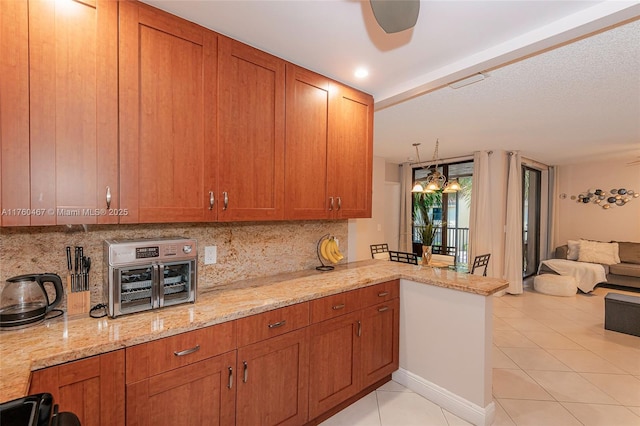2888 S Carambola Cir S Unit 2079, Coconut Creek, FL 33066 - kitchen with light tile patterned floors, tasteful backsplash, and brown cabinetry