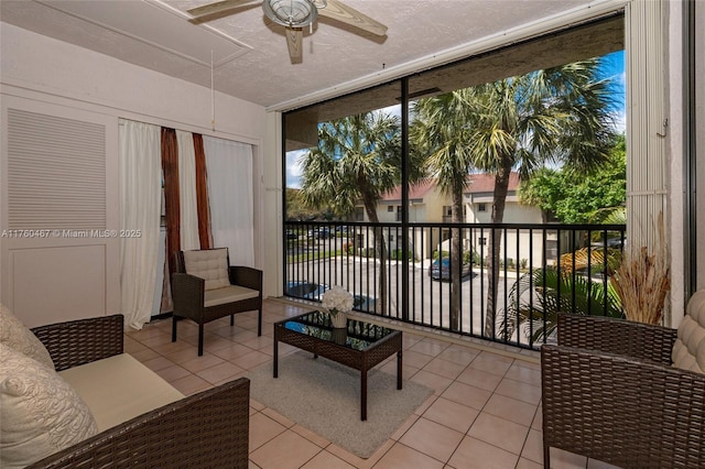 sunroom featuring a ceiling fan