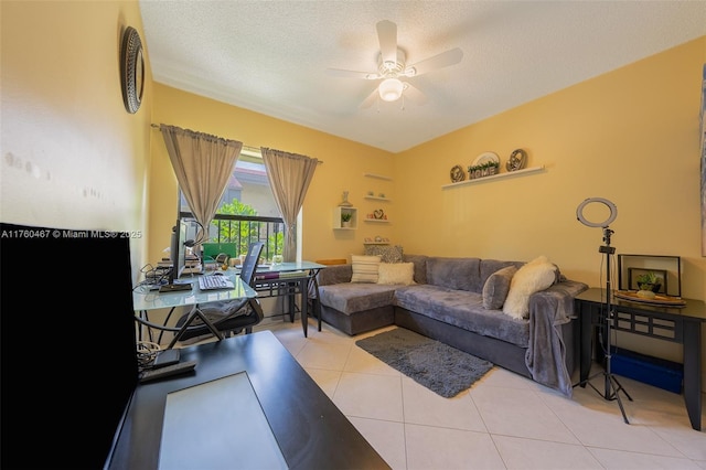 2888 S Carambola Cir S Unit 2079, Coconut Creek, FL 33066 - living room featuring ceiling fan, light tile patterned floors, and a textured ceiling
