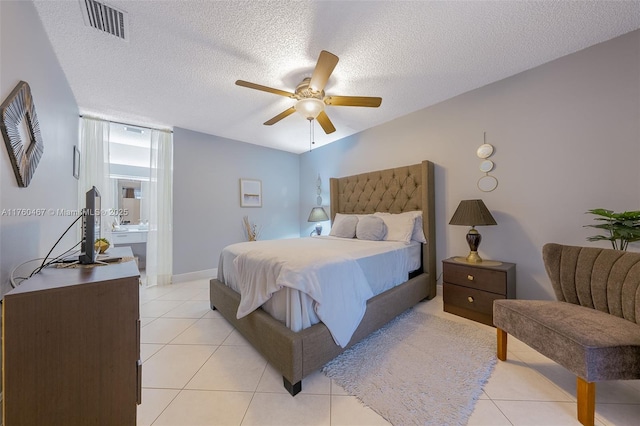 2888 S Carambola Cir S Unit 2079, Coconut Creek, FL 33066 - bedroom with light tile patterned floors, a textured ceiling, and a ceiling fan