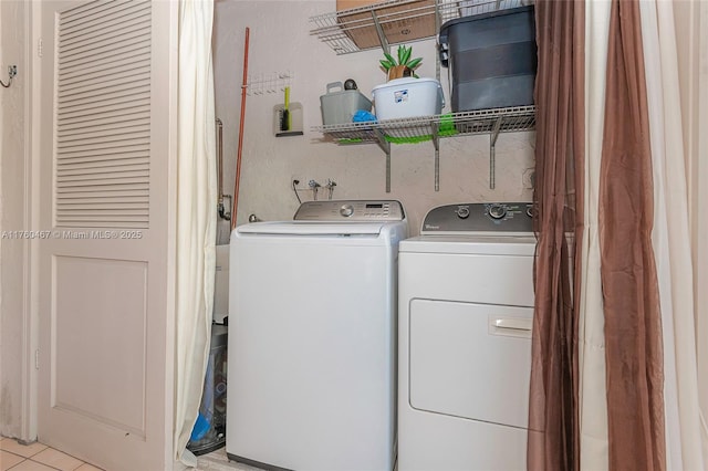 2888 S Carambola Cir S Unit 2079, Coconut Creek, FL 33066 - laundry area with washer and dryer and light tile patterned flooring