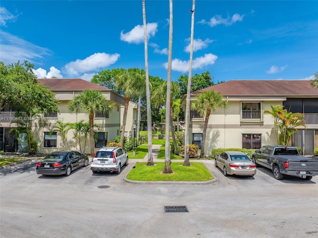 2888 S Carambola Cir S Unit 2079, Coconut Creek, FL 33066 - view of building exterior with uncovered parking