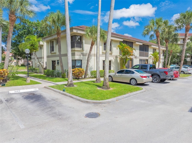 2888 S Carambola Cir S Unit 2079, Coconut Creek, FL 33066 - view of property featuring uncovered parking