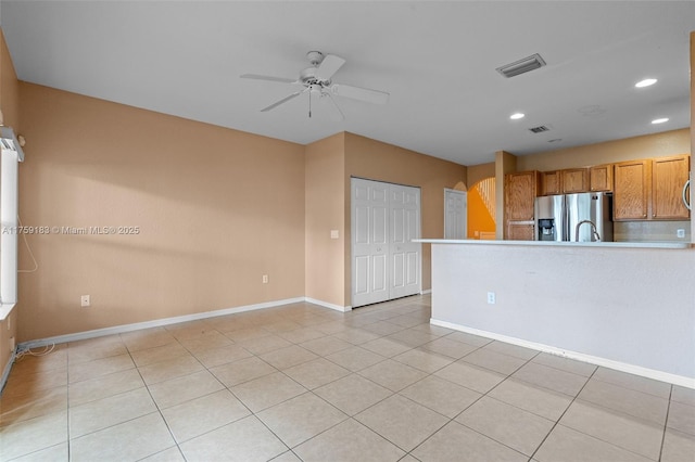 interior space with visible vents, recessed lighting, light tile patterned floors, baseboards, and ceiling fan