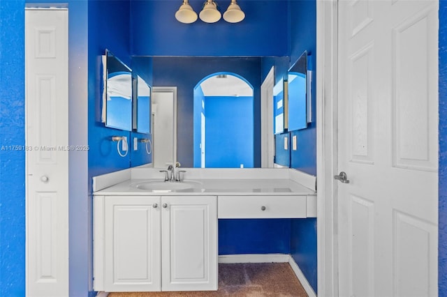 bathroom with vanity and baseboards