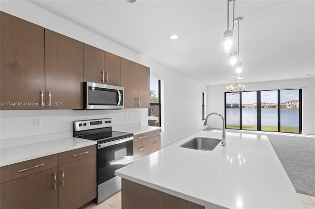 kitchen with light countertops, a healthy amount of sunlight, appliances with stainless steel finishes, and a sink