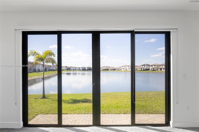 doorway with a residential view and a water view