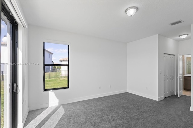 unfurnished bedroom with visible vents, baseboards, and carpet