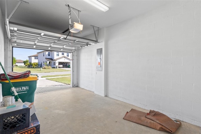 garage featuring electric panel and a garage door opener