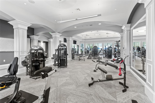 workout area featuring visible vents, carpet floors, decorative columns, recessed lighting, and arched walkways