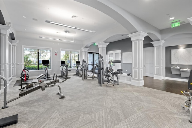 exercise room featuring visible vents, recessed lighting, carpet, decorative columns, and baseboards