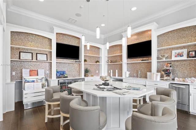 kitchen featuring dark wood-style floors, white cabinets, crown molding, and backsplash