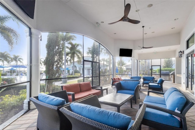 sunroom featuring a ceiling fan