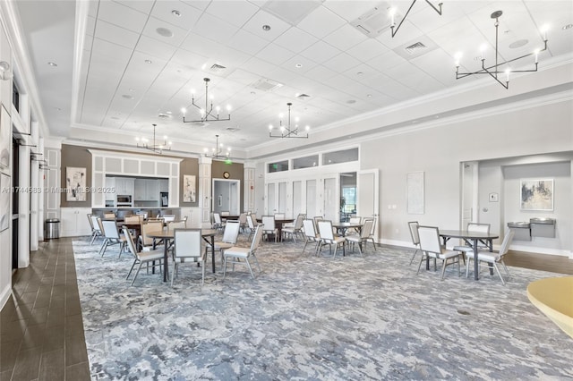 dining room featuring visible vents, a raised ceiling, and ornamental molding