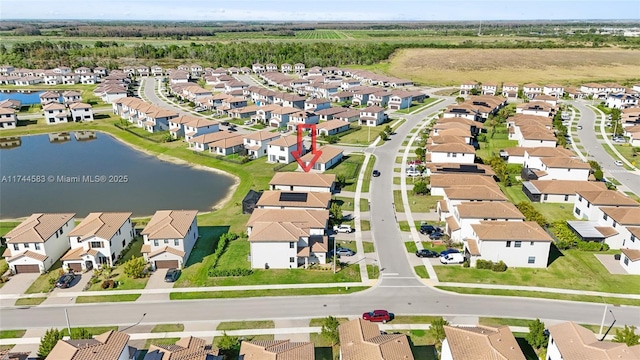 drone / aerial view with a residential view and a water view