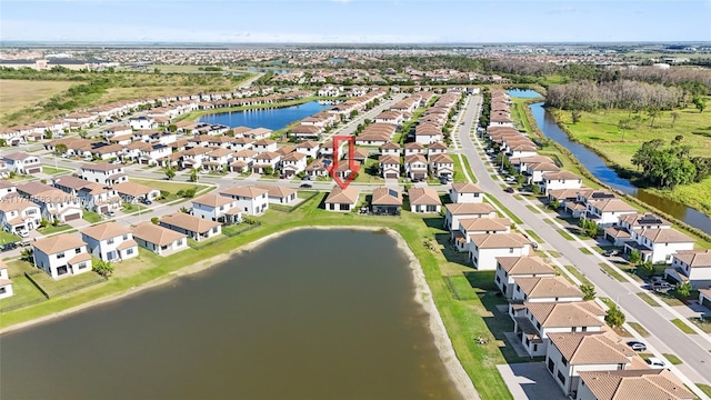 drone / aerial view with a water view and a residential view