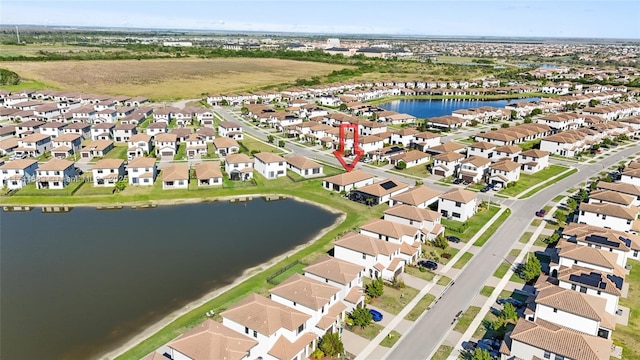 bird's eye view featuring a residential view and a water view