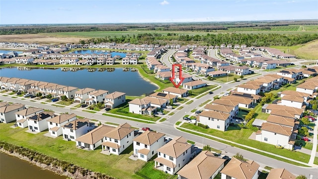 birds eye view of property featuring a residential view and a water view