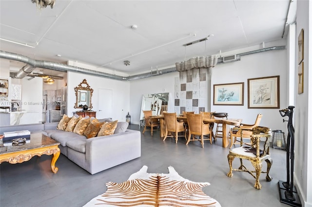 living area featuring visible vents and concrete flooring