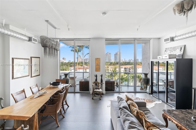 dining area featuring visible vents, a view of city, and floor to ceiling windows