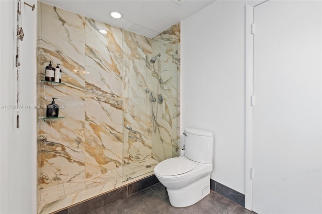 full bathroom featuring a marble finish shower, tile patterned floors, and toilet